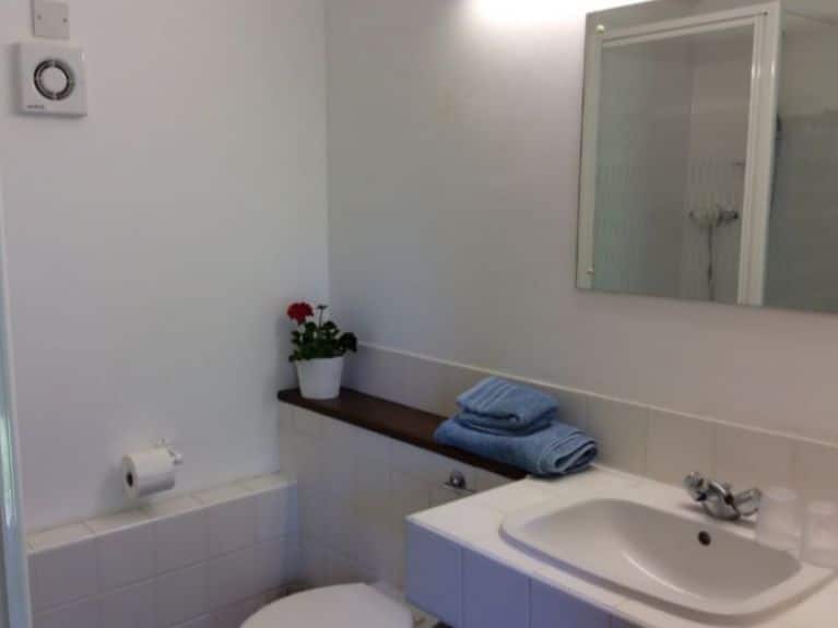 Ground level tiled shower room with heated towel rail
